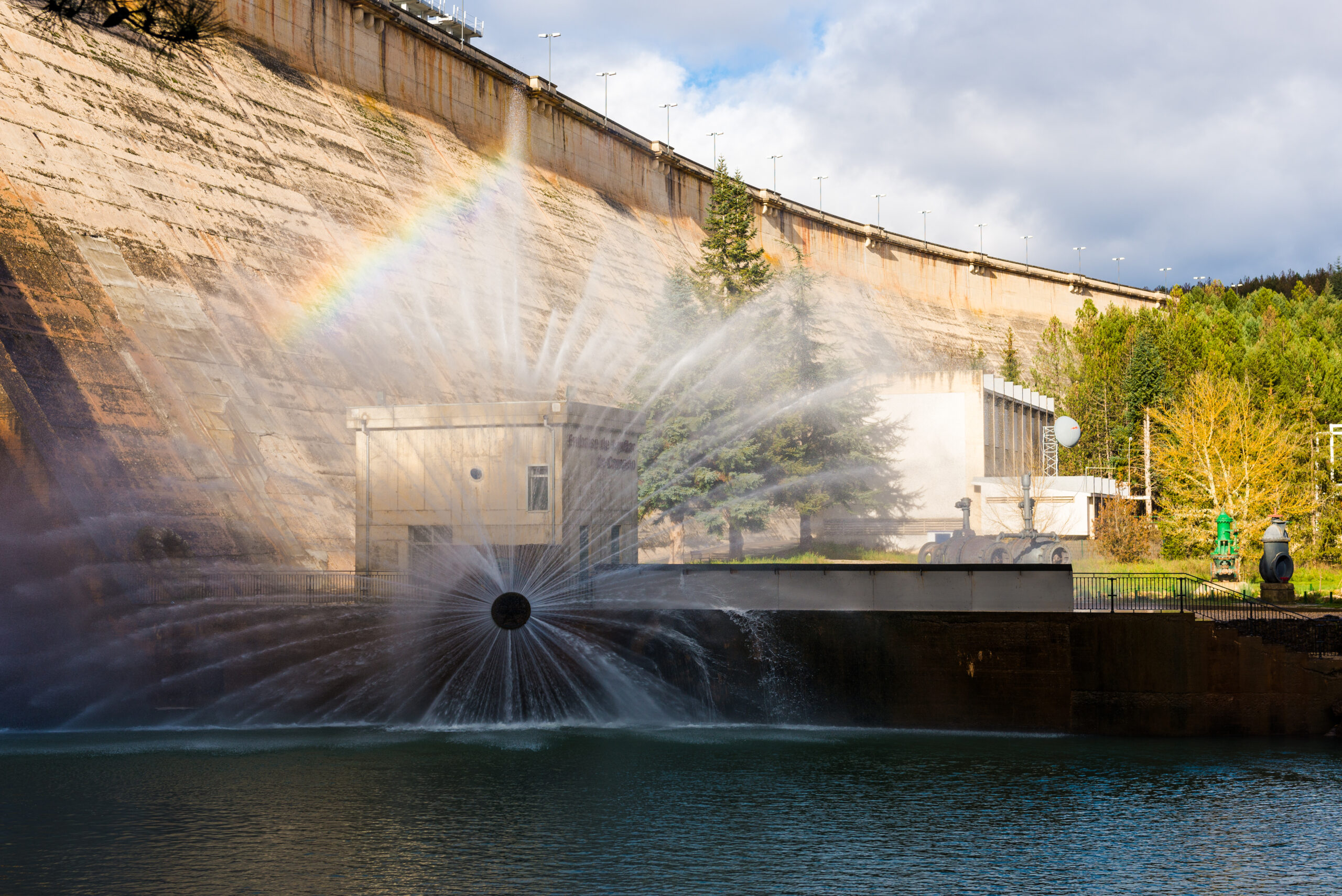 Concrete hydroelectric power station in sunlight